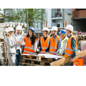 A group of people in hi vis jackets and hard hats standing in a construction site.