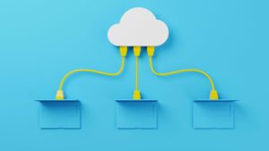 There is a sky blue solid cover background. There is a model of a white cloud which is cartoon like. There are three yellow ethernet cables coming out of the cloud and plugging into sky blue coloured laptops. This is the image for the skills bootcamp in digital cloud.