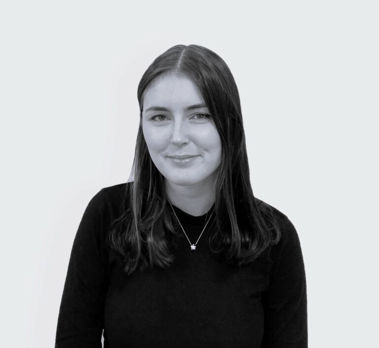 Black and white photo of a young white woman looking into the camera