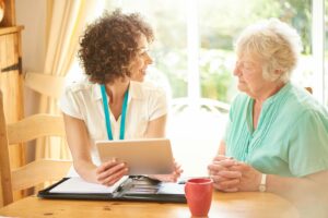 a social worker talking with an older lady