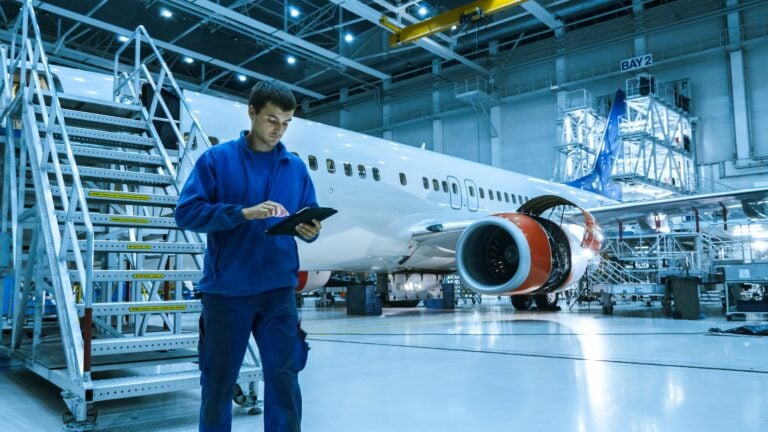 an engineer with an aircraft in the background