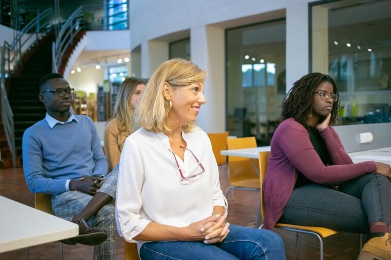 students sitting together and listening to classmate
