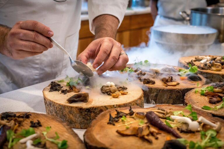 Hands of a chef plating up rustic food