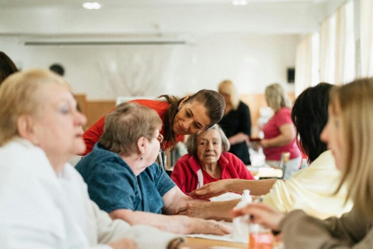 Elderly people sat in a care home